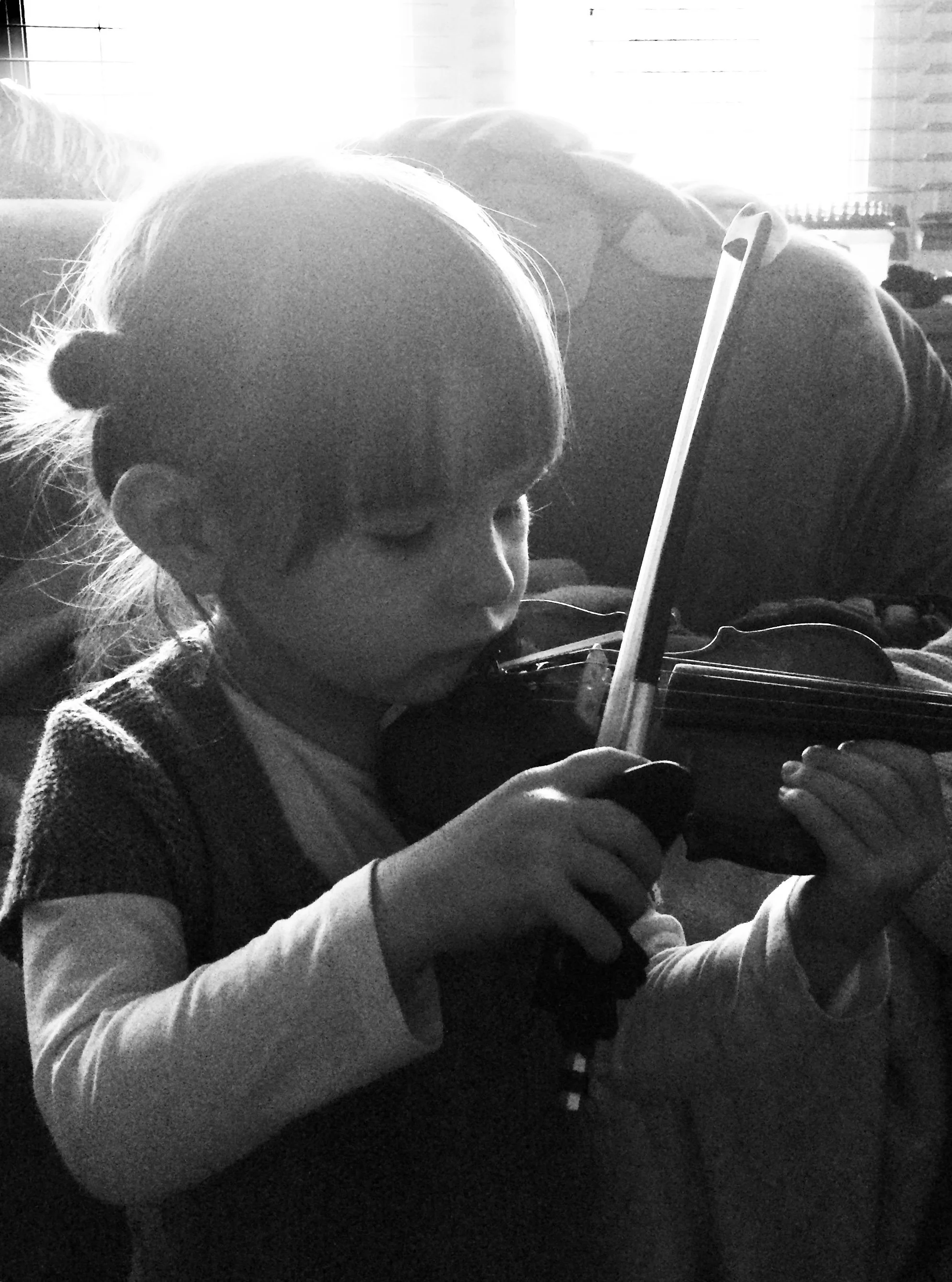 Child learning to play the violin